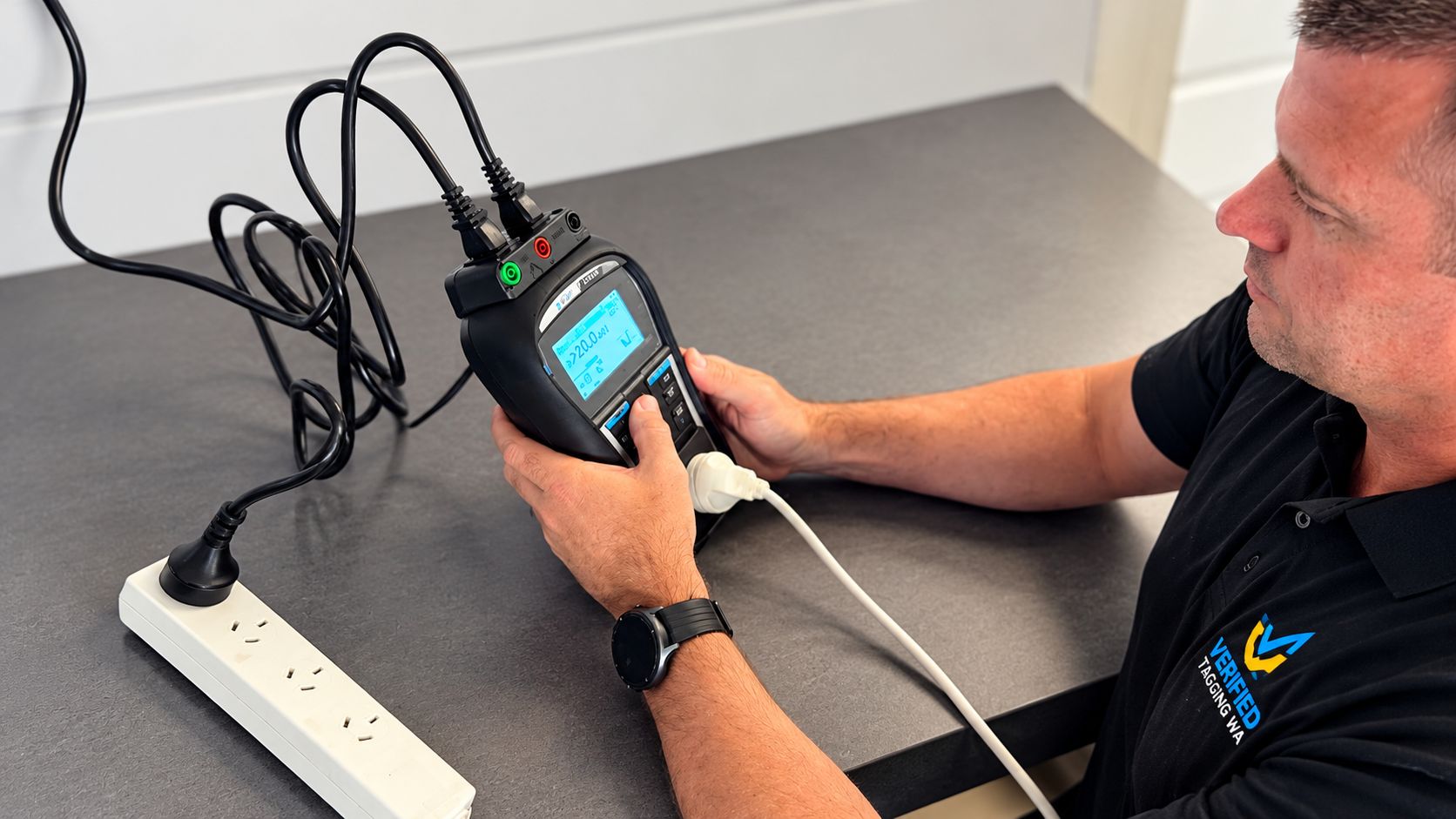 Leigh Walton testing an appliance with a portable appliance tester